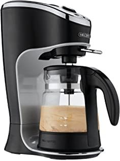 a black coffee maker sitting on top of a white counter next to a glass cup