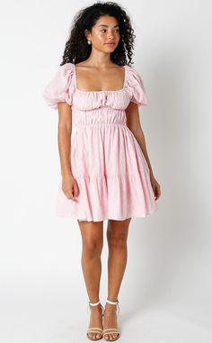 Get ready to feel fabulous in the Kendall Pink Eyelet Puff Sleeve Mini Dress! It's sure to bring a playful and fun vibe to your wardrobe. This puff sleeve mini dress is made from pink and cream pierced eyelet lace fabric, with a smocked corset-inspired bodice, a square neckline, and an attached tiered mini skirt. Style with heels for an elevated look! DETAILS & FIT S: 30" length, 25" waist, 32" bust M: 30.5" length, 27" waist, 33" bust L: 31" length, 29" waist, 35" bust 100% Cotton. Machine wash Summer Pink Puff Sleeve Dress For Day Out, Cute Fitted Dress With Balloon Sleeves, Cute Puff Sleeve Mini Dress For Brunch, Sweet Puff Sleeve Summer Dress, Sweet Summer Dress With Puff Sleeves, Spring Cute Puff Sleeve Dress With Balloon Sleeves, Cute Mini Puff Sleeve Dress With Ruffle Hem, Pink Puff Sleeve Dress For Spring Day Out, Cute Fitted Puff Sleeve Dress