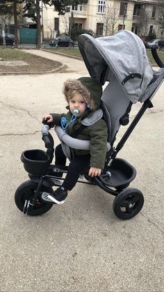 a small child in a stroller on the street