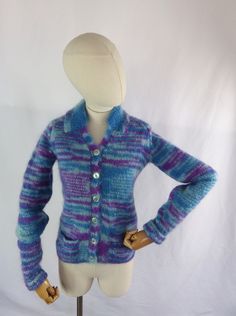 a female mannequin wearing a blue and purple striped cardigan with gold buttons