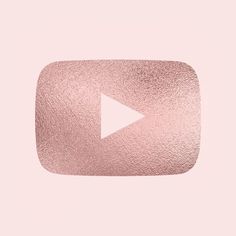 a pink square with a white arrow on it's center and the word youtube written in cursive writing