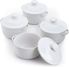 four white dishes with lids and spoons