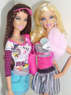 two barbie dolls standing next to each other