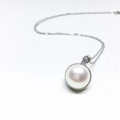 Our Unique Pendant Is Designed With White Freshwater Pearl , Cubic Zirconia And 925 Sterling Silver. You Can Wear It All Day Long. Jewelry : Pearl Pendant Pearl Type : Freshwater Pearl Pearl Grade : AAA+ Pearl Luster : High Pearl Body : Clean Pearl Shape : Round/ *Button Pearl Nacre : All (100% nacre)  Necklace Length : 18 Inches = 45.7cm  Pearl Color : *White/Pink/Gray/Black Pearl Size: Approx  10-11mm / 11-12mm Clasp : 925 Sterling Silver Metal: Sterling silver Sterling Silver Chain: 18 inches Size Of Pendant : Approx  Length 20mm x 15mm Width *Nice Jewelry Box Wrap Thanks For Choosing Blest Jewellery :)   Blest Jewellery *Professional Jewellery Design  (since 2010)  Website: http://blestjewellery.yolasite.com online shop : www.etsy.com/shop/blestjewellery Facebook /Instagram search : bl Elegant Necklace With Sterling Silver Clasp And Round Pendant, Elegant Necklace With Sterling Silver Round Pendant, Elegant Sterling Silver Clasp Jewelry With Round Pendant, Elegant Sterling Silver Clasp Round Pendant Jewelry, Elegant Jewelry With Sterling Silver Clasp And Round Pendant, Fine Jewelry Pearl White Sterling Silver Necklace, Fine Jewelry Sterling Silver Necklace In Pearl White, Fine Jewelry Sterling Silver Necklaces In Pearl White, Fine Jewelry Pearl White Sterling Silver Necklaces