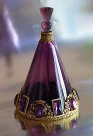 a purple glass vase with gold trimming