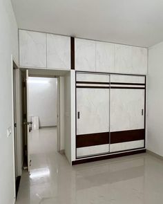 an empty room with white and brown doors