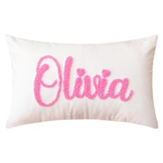 a white pillow with pink lettering that says,'elvia'in cursive font