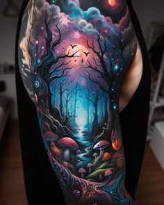 a woman's arm with an image of a forest and moon in the sky