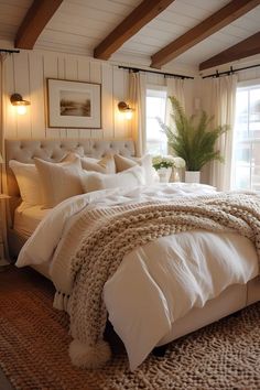 a bed with white linens and pillows in a bedroom