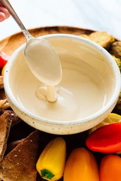 a spoon is being used to dip some food into a bowl