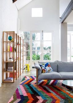 a living room filled with furniture and colorful rugs