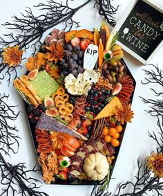 a table topped with lots of different types of food and halloween decorations on top of it