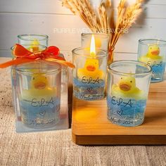 four ducky candles are sitting on a table