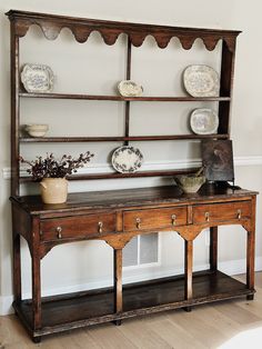 an old wooden shelf with plates on it