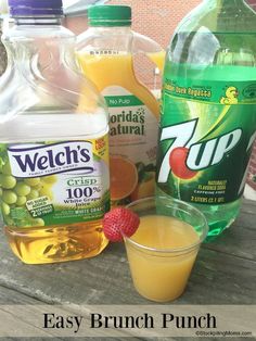 bottles of orange juice, lemonade and raspberries on a picnic table with text overlay