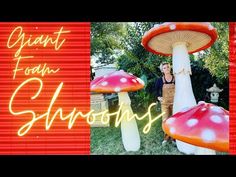 a woman standing in front of two giant mushroom shaped structures with the words giant toad's on them