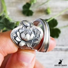 A beautiful rendition of Art Nouveau lotus blossoms on this ring! Lotus blossoms, often revered as symbols of purity and enlightenment, unfurl their exquisite petals atop tranquil waters, embodying grace and resilience. Emerging from the mud, these stunning flowers remind us that beauty can arise from the most challenging circumstances, inspiring a sense of renewal and spiritual awakening. Made from a Paye & Baker spoon from the early 1900s, fine detail and unique styling sets this floral ring a Unique Adjustable Flower Ring For Wedding, Heirloom Flower Ring For A Gift, Heirloom Flower Ring Gift, Unique Flower Shaped Wedding Rings, Unique Wedding Rings With Flower Shape, Unique Flower-shaped Anniversary Ring, Heirloom Flower Shaped Silver Ring, Adjustable Spiritual Flower Ring For Promise, Heirloom Silver Flower Ring