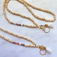 "Materials: 7mm Multi-Color Letter Beads 8mm Raw Wood Beads *Raw wood is not perfect in nature - expect small imperfections* How to order: 1. Select Style + With or Without Tassel (see color chart for tassel options) 2. Select Length (see photo chart for guidance) Standard = 36\" Long = 40\" Extra Long = 42\" 3. In personalization box list: List name request - check spelling! If you want a specific color/pattern from the multi-color beads, request here and I will do my best to accommodate - defa Wood Bead Lanyard, Diy Lanyards, Silicone Crafts, Coach Lanyard, Teacher Lanyards, Bead Lanyard, Teacher Fits, Diy Lanyard, Nurse Lanyard