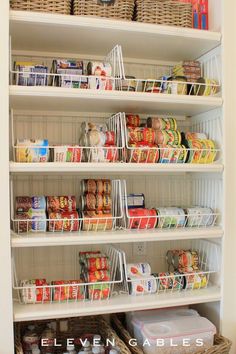 an organized pantry with white shelves filled with food