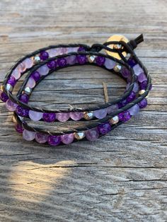 This 2-toned purple wrap bracelet is a one of a kind.  Glitter purple beads with a pastel purple bead all wrapped in black leather.  Silver plated beads are intermittently dispersed  The closure is a silver colored button.  I don't know about you but just working with purple beads has the happy vibes going. Adjustable Hand-wrapped Purple Beaded Bracelet, Hand Wrapped Purple Bracelets, Adjustable Hand Wrapped Purple Bracelets, Adjustable Purple Beaded Spiritual Bracelets, Adjustable Purple Beaded Bracelets For Healing, Adjustable Purple Spiritual Beaded Bracelets, Adjustable Handmade Purple Wrap Bracelet, Handmade Purple Wrap Bracelet As Gift, Adjustable Spiritual Wrap Bracelet With Faceted Beads