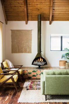 a living room filled with furniture and a fire place in the middle of the room