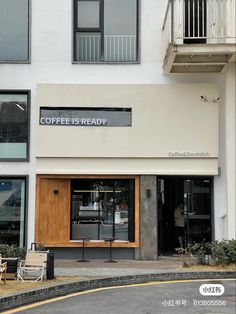 the outside of a coffee shop with tables and chairs