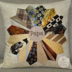 a pillow that has ties on it and the word papa written in large letters