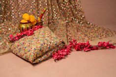 two vases with flowers on top of them next to some fabric