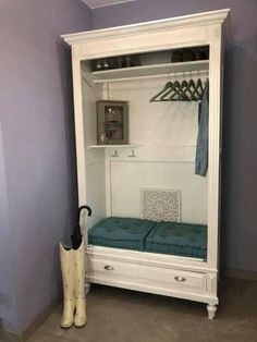 a white cabinet with a blue cushion and umbrella