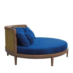 a blue chaise lounge chair with pillows on it's back and arms, in front of a white background