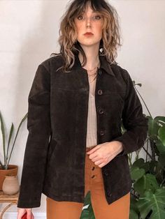 This timeless dark brown leather jacket checks all the boxes. Made from a dark chocolate suede leather in great condition and features a boxy relaxed fit with a unique button up front where only the top 2 chunky brown buttons are visible. I love themed chest split seam, and slanted hip pockets on this classic Indie minimalist jacket. Pair with your favorite denim and Chelsea boots for a Fall look that never goes out of style. #suedeleather #leatherjacketoutfit #suedeleatherjacket Minimalist Jacket, Dark Brown Leather Jacket, Suede Leather Jacket, Leather Jacket Outfits, Brown Leather Jacket, Dark Brown Leather