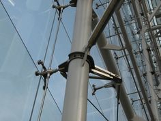 looking up at the side of a glass and steel structure