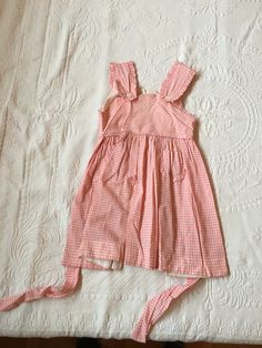 Vintage Kids pink patterned summer dress. Straps attach with buttons. No size on garment but would likely fit ages 6-8. Has small stains on fabric, pictured. Cute Pink Dresses With Buttons, Cute Lined Cotton Sundress, Cute Pink Sundress For Daywear, Cute Sleeveless Dress With Button Closure, Cute Pink Dress With Buttons, Summer Cotton Vintage Dress For Picnic, Cotton Vintage Dress With Buttons For Summer, Pink Cotton Sundress For Picnic, Pink Summer Dress With Buttons