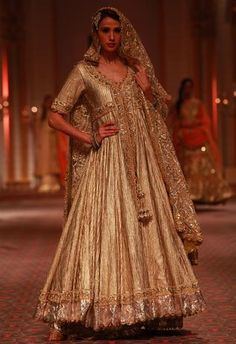 A beige shimmer anarkali featuring gold zardosi and gota embroidery. It comes along with a gold embroidered net dupatta and has a relaxed fit. - Aza Fashions Desi Wardrobe, Salwar Kamiz, Falls Church, Indian Bridal Wear, Indian Couture, Bridal Dress Design, Indian Weddings, Designer Blouse, Bridal Fashion Week