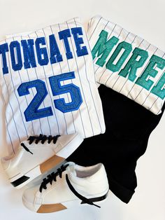 Stand out at the game with our Custom Pinstripe Baseball Jersey. This jersey features intricate embroidery and glitter applique, making it truly one-of-a-kind. Show off your unique style and personality with this playful and fun addition to your baseball gear. (And impress your teams, too!) Pricing includes one name on the back and one number, additional customization can be added, please ask for details on pricing! PLEASE NOTE the name and number, as well as glitter color in the notes! Product Details Feature: Pad print label Set-in sleeves Full-button jersey Double-needle hemmed sleeves and fishtail bottom. Sizing - See attached photo Fabric : 100% polyester smooth pinstripe knit / Wicks moisture away from the body Fit - Classic unisex fit Made to order: one week ship time Sporty Baseball Jersey With Contrast Stripes, Varsity Baseball Jersey With Contrast Stripes, Varsity Tops With Embroidered Graphics For Game Day, Collegiate Tops With Embroidered Graphics For Game Day, Varsity Tops With Embroidered Graphics, Varsity Baseball Jersey For Game Day, Varsity Top With Embroidered Logo For Sports Events, Game Day Tops With Embroidered Graphics For Sports Season, Varsity Tops With Embroidered Graphics For Sports Events