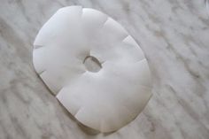 a white doughnut sitting on top of a marble counter