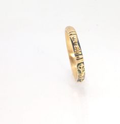 This is the most narrow of my Memento Mori rings at 3mm wide and is cast in 14k rich yellow gold. The Skeleton is flanked by intertwined hearts on one side.14k rich yellow gold and EnamelMade to Order. Usually ships in 3-5 days.This ring looks great as part of a stack, as a wedding band, a right-hand ring, or a promise ring, and all by its damn self, thank you very much. And as always, my rings are Unisex. Y’all wear what you want!I made these Memento Mori rings for my older sister Jill, a famou 14k Yellow Gold Engraved Bands, Engraved 14k Yellow Gold Bands, Ceremonial Gold Engraved Ring With Engraving Option, Antique Etched Yellow Gold Rings, 14k Gold Symbolic Rings With Engraving Option, Ceremonial 14k Gold Engraved Ring, Etched 14k Gold Rings, Yellow Gold Brass Stackable Rings For Wedding, Engraved Gold Rings In Recycled Gold