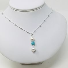 Beautiful triple drop pendant. This Larimar and freshwater Pearl pendant is a perfect gift to bring the tropics to someone special in your life! Two beautiful cultured baroque shaped freshwater pearls and one round Larimar bead hang from this beautiful sparkly sterling silver chain. Chain is Sterling Silver and sparkles beautifully with small moon cut beads evenly spaced throughout. Chain is also beautiful on its own or layered with other delicate necklaces. Features: 18 inch sterling silver. One Larimar stones (size 8mm). Two cultured freshwater Baroque Pearls (8.5-9.5mm). Excellent luster. Handmade and designed in Stuart, FL and shipped from the US * In order to create unique and distinctive pieces, I use diverse shapes of natural gems to ensure that no two pieces are exactly the same. A Turquoise Pearl Drop Jewelry, Turquoise Pearl Necklace With Pearl Charm As Gift, Turquoise Pearl Necklace Gift, Turquoise Pearl Necklace As A Gift, Turquoise Necklace With Pearl Drop As Gift, Turquoise Necklace With Pearl Drop For Gift, Turquoise Pearl Pendant Necklace As Gift, Moon Cut, Larimar Necklace