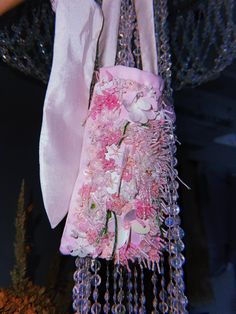 A small handbag sewn from delicate pink satin. This bag has two long textile handles from taffeta that can be tied to create the length you need. Flowers made of Japanese and Czech beads and bugle and Italian sequins are embroidered. Size: Length - 19 cm Height - 10 cm Width - 5.5 cm The length of the handle is 49 cm with carabines Pink Floral Embroidery Evening Bag, Pink Pearl Embroidery Bags For Wedding, Pink Wedding Bag With Pearl Embroidery, Pink Wedding Bags With Pearl Embroidery, Handmade Bags For Spring Wedding, Handmade Pink Evening Bag For Events, Spring Wedding Handmade Bags, Pink Flower-shaped Party Bag, Pink Spring Evening Bag For Events