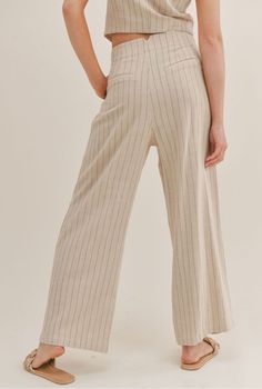 Our Forever Muse Pinstripe Pants has a wide leg fit and a front zip closure. The lightweight feel of the fabric allows you to move comfortably while looking put together. Front Zipper Closure Inverted Front Pleats 70% RAYON 30% LINEN Model is wearing a size small. LE1703 Striped Wide Leg Trousers With Elastic Waistband, Spring Wide Leg Pants With Vertical Stripes, Summer Wide-leg Pants With Contrast Stripes, Summer Wide Leg Pants With Contrast Stripes, Chic Wide Leg Bottoms With Vertical Stripes, Spring Striped High-waisted Wide Leg Pants, Casual Pinstripe Wide-leg Bottoms, Casual Pinstripe Wide Leg Bottoms, Pinstripe Wide Leg Pants For Spring