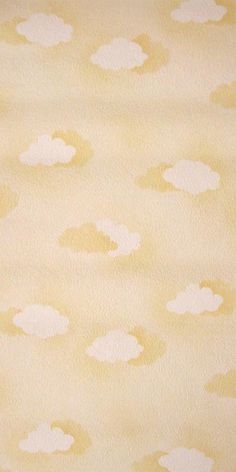 a yellow and white wall with clouds painted on it