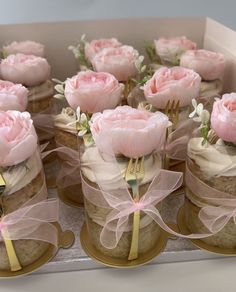 there are many cupcakes with pink flowers on them