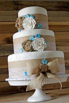 three tiered wedding cake decorated with burlocks and flowers