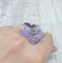 Natural Amethyst carved stone flower rings - adjustable from size 6 to 10. Colorful purple and green gemstone rings with olive green olivine ( peridot ) in the middle or purple amethyst flower. Handmade rings, boho jewelry. Amethyst flowers are 30 mm wide and 5 mm thick. Olivine round stones measure 5 mm. Amethyst flower has a hole in the middle, it is set on a metal post and help with one round piece of olivine chrysolite on top. I used some clear glue to make the stones hold stronger. Due to t Rings Purple, Green Agate Ring, Rings Adjustable, Rings Boho, Amethyst Flower, Metal Post, Flower Rings, Green Gemstone Ring, Clear Glue