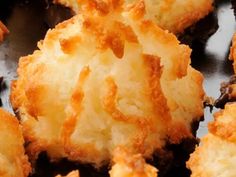 closeup of some fried food on a black plate with brown grated crusts