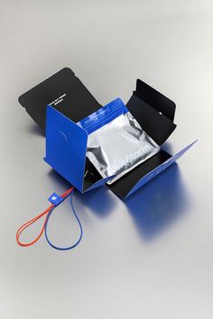 an open blue box with a pair of scissors in it sitting on top of a table