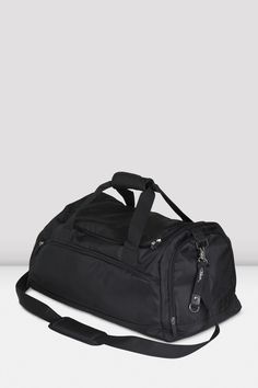 a black duffel bag sitting on top of a white table