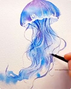 a drawing of a jellyfish with blue watercolors on it's body