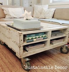 a coffee table made out of an old crate with wheels on it and books stacked on top