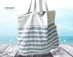 This huge striped linen bag will fit all your necessary beach belongings and there will still be enough space for shopping. White and light blue stripes give marine ambience to your leisure. It is very lightweight and capacious, with a big inner pocket convenient for quick access to your necessary belongings. The handles comfortably fit your shoulders. The handles colors and pocket design may vary. Please, get in touch before purchasing to chose exact option. Dimensions: 20,9x16,9 in / 53x43 cm Oversized Beach Bags, Oversized Bag, Summer Bag, Linen Bag, Shoulder Tote Bag, Striped Linen, Navy Stripes, Print Tote, Shoulder Tote